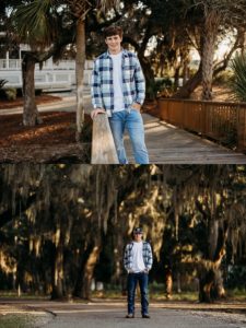 senior boy in front of tall southern oak trees